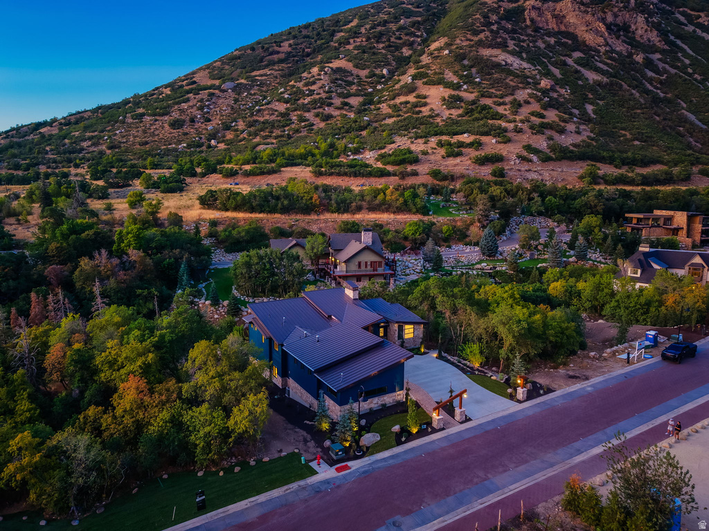 Modern mountain residence featuring a prominent metal roof, stone accents, and a distinctive dark-toned siding