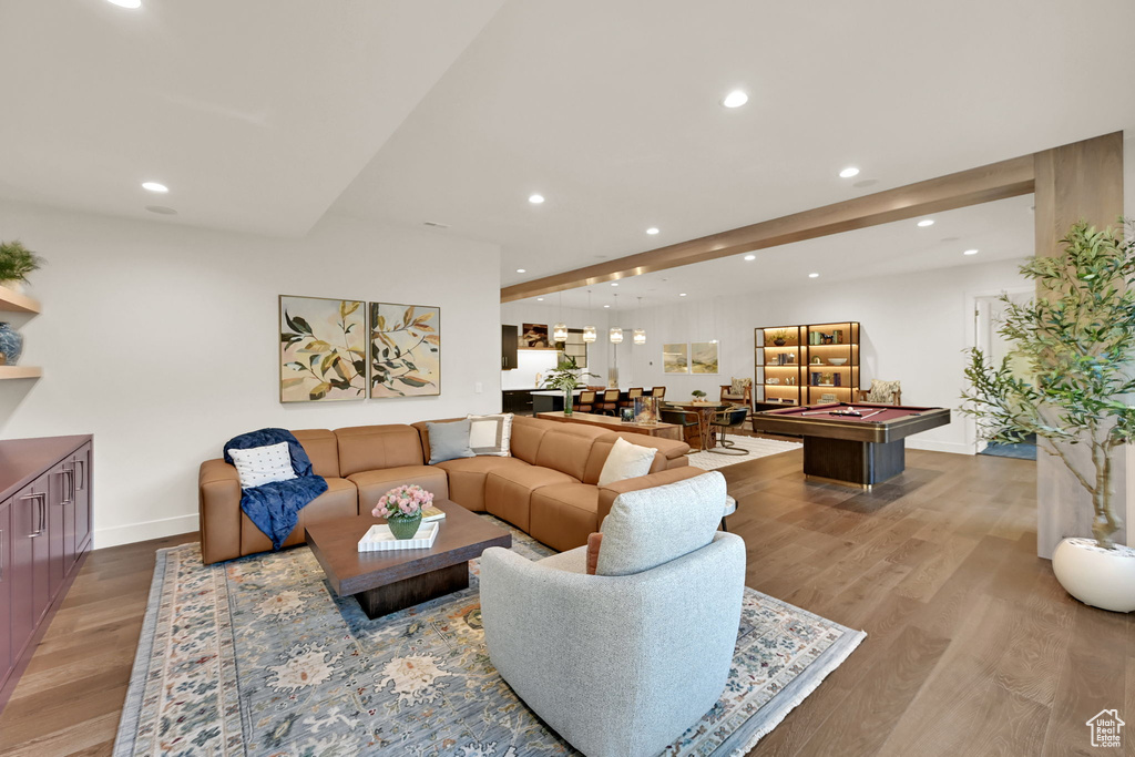 Open-concept entertaining area featuring recessed lighting, wide plank wood-finish flooring, and a dedicated billiards space