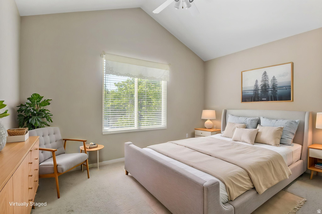 Vaulted ceiling bedroom featuring a ceiling fan, a large window with blinds, and neutral tone carpeting