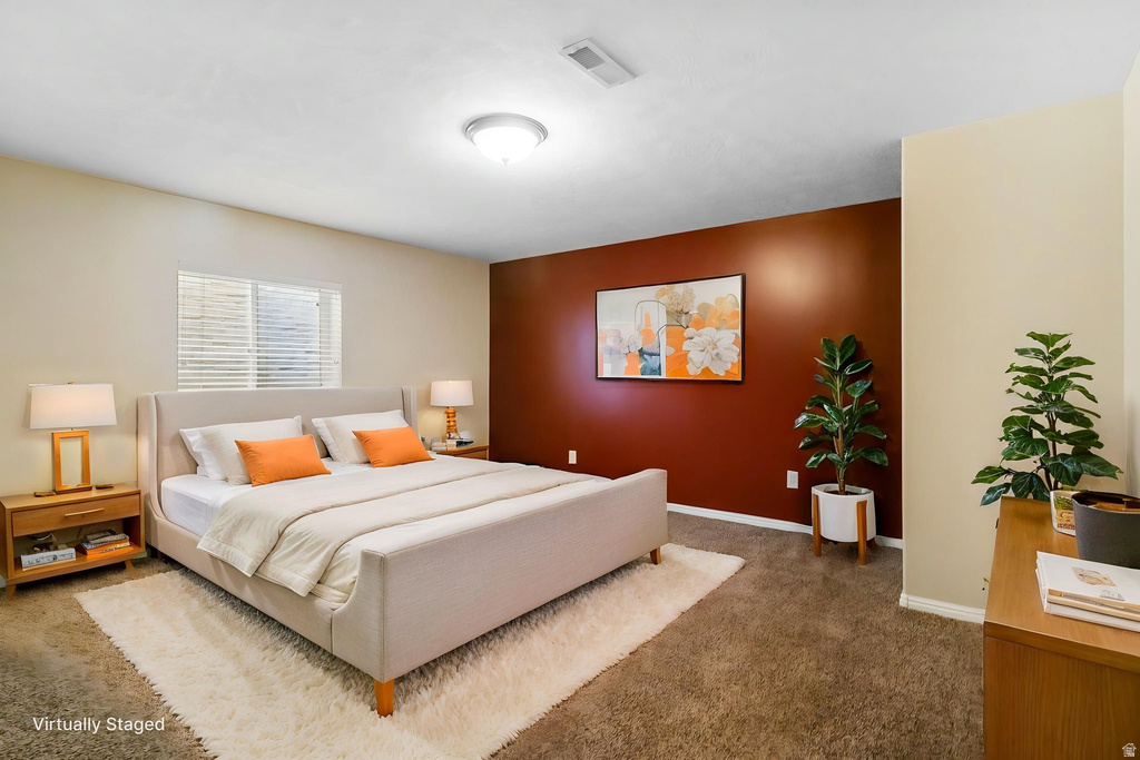 Carpeted room featuring a window with blinds, a contrasting accent wall, and a ceiling-mounted light fixture
