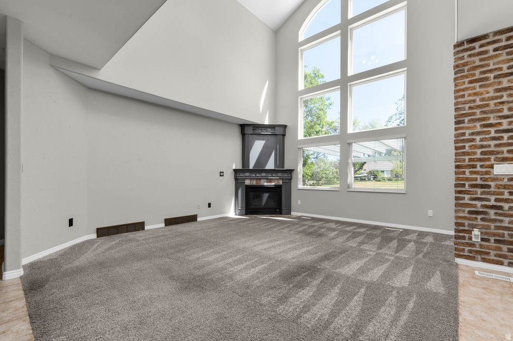 Two-story living area featuring a prominent window wall with an arched top frame