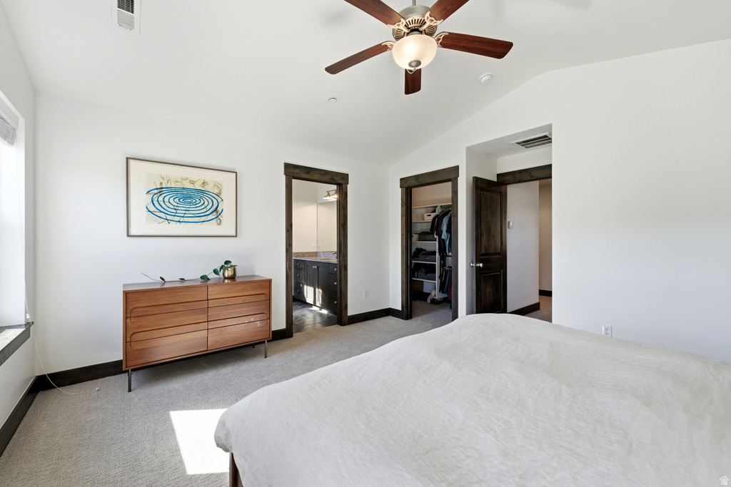 Bright room with vaulted ceilings, recessed lighting, a ceiling fan with light fixture, and wood-finish trim around doorways and windows