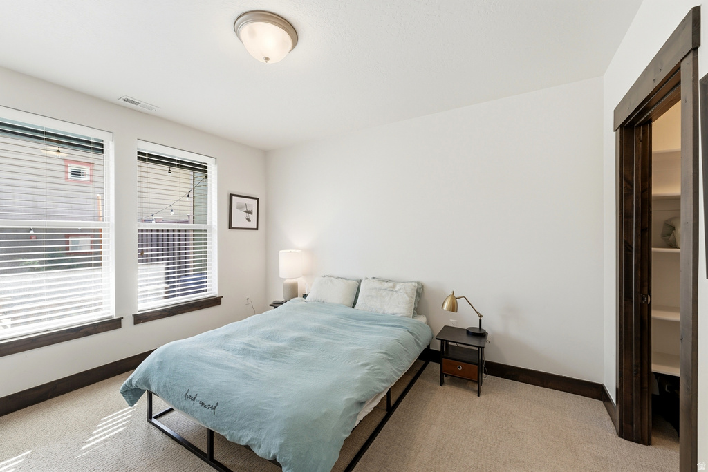 Room featuring two windows with horizontal blinds, providing ample natural light