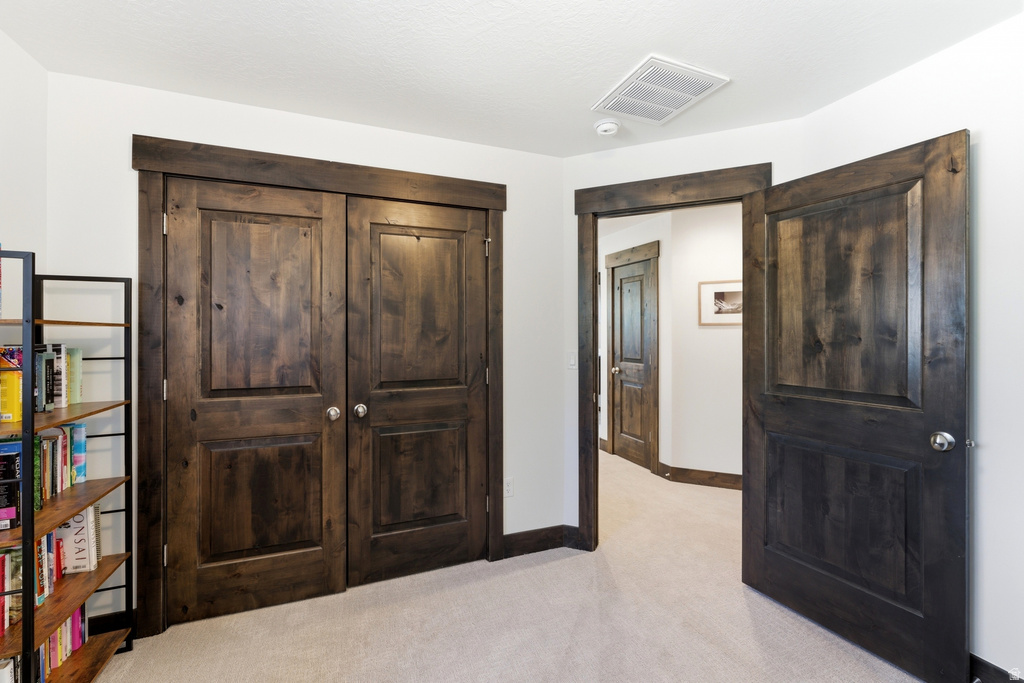 Interior space featuring dark wood-finish doors with panel details and matching trim