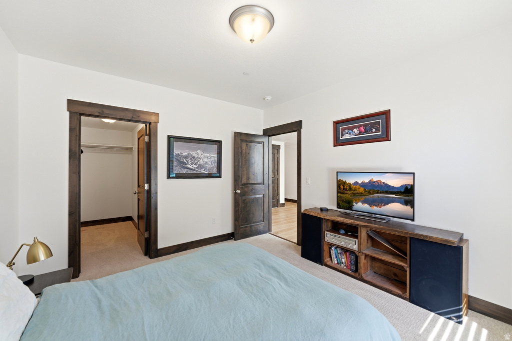 Carpeted bedroom featuring white walls, dark wood-finish trim, and a semi-flush mount ceiling light fixture