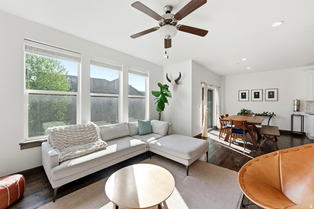 Open concept living area featuring dark wood-finish flooring, a contemporary ceiling fan, and recessed lighting
