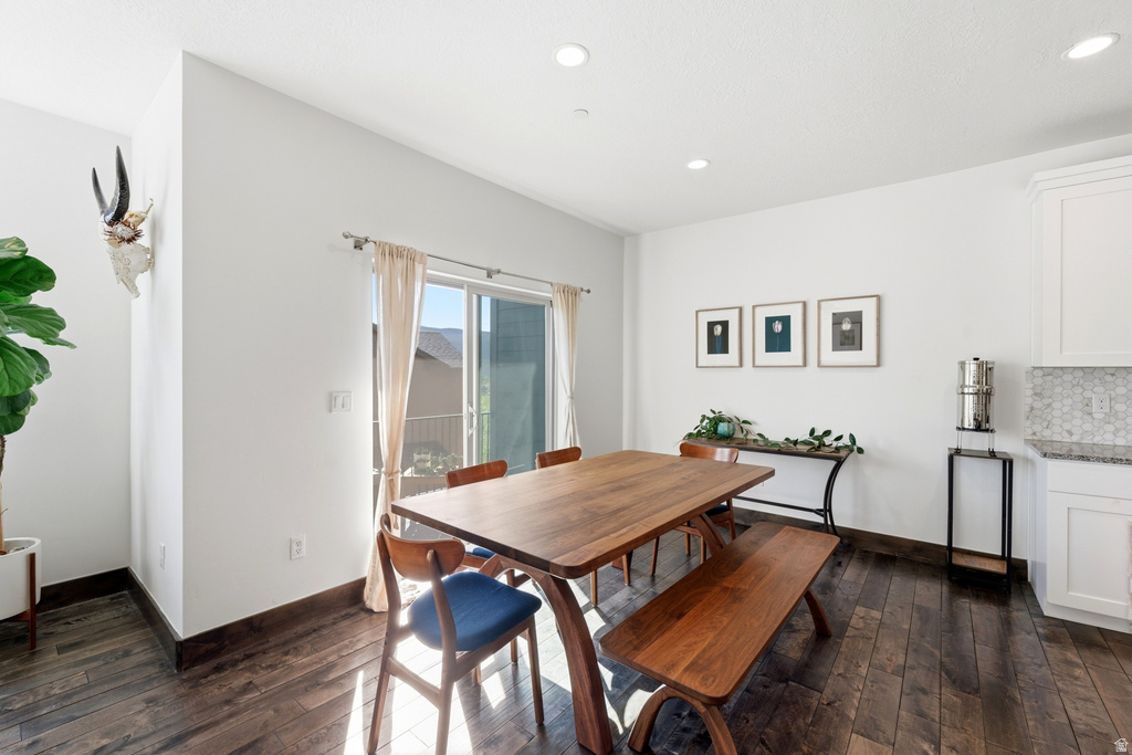 Dining area featuring wood-finish flooring, recessed lighting, and a sliding glass door to an exterior space