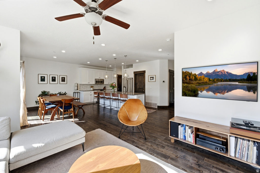 Spacious living area featuring wood-finish flooring, recessed lighting, and a ceiling fan