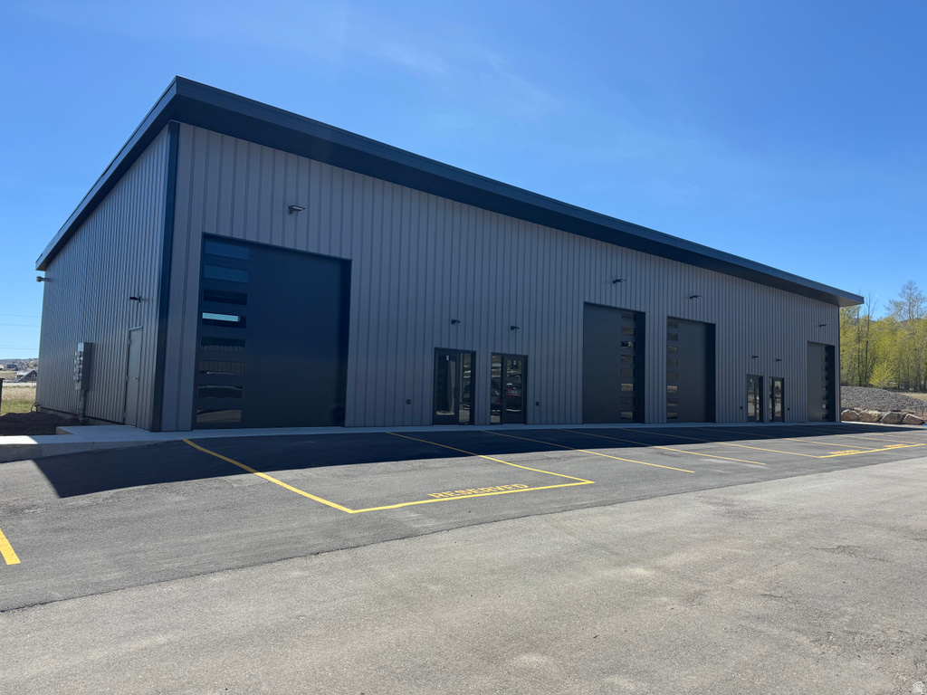 Modern industrial building featuring corrugated metal siding and a flat roofline