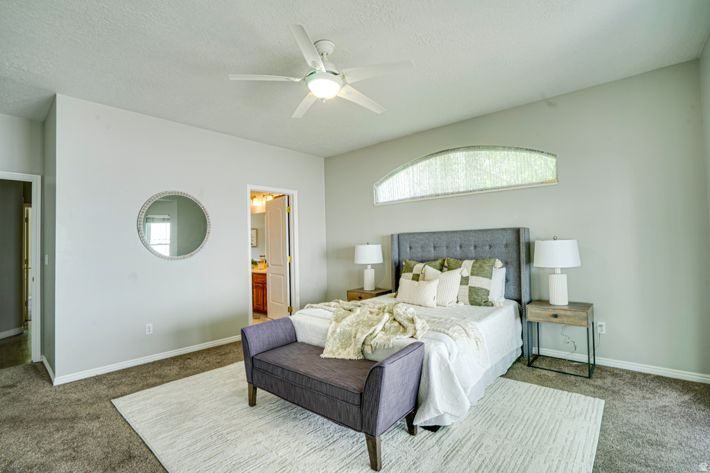 Bedroom featuring an arched window, ceiling fan, and light gray wall paint
