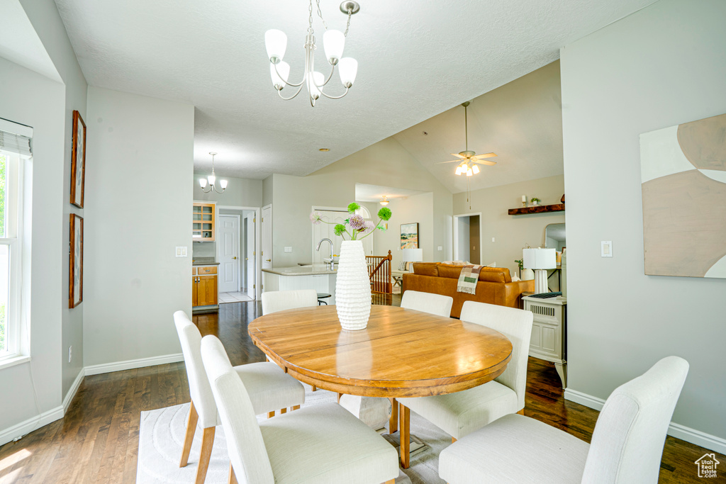 Dining area featuring wood-finish flooring, a contemporary chandelier, and light gray wall tones