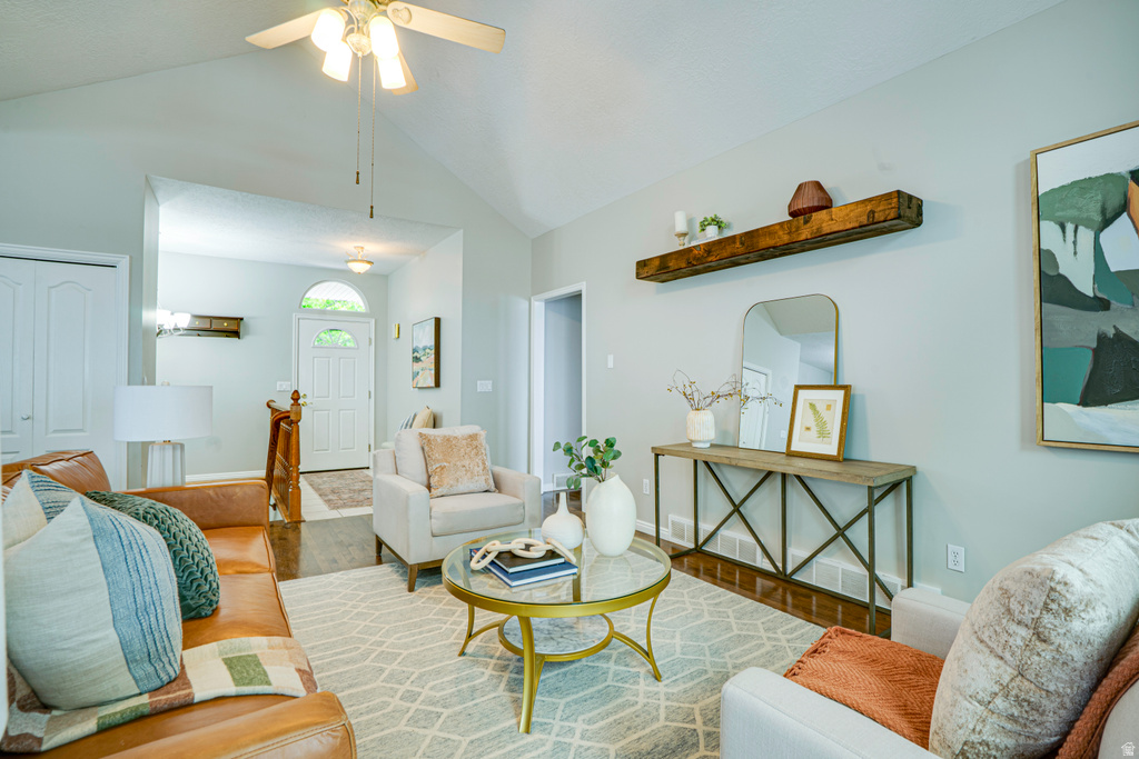 Vaulted ceilings defining a living space with wood-finish flooring