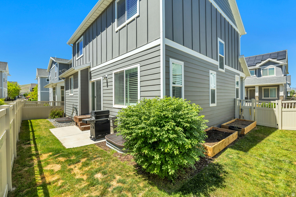 Rear exterior featuring gray horizontal siding and vertical board and batten accents
