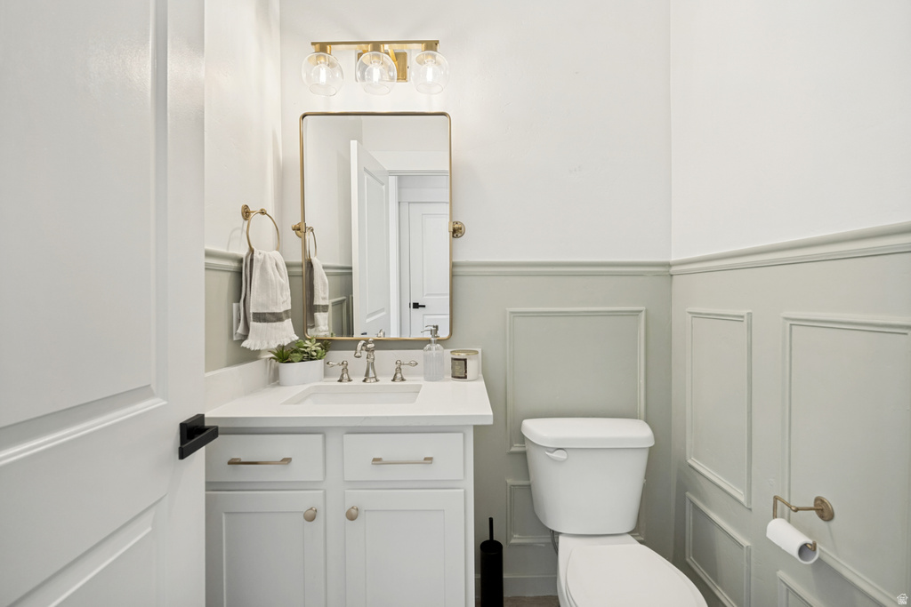 Vanity featuring a white countertop, undermount sink, and chrome faucet