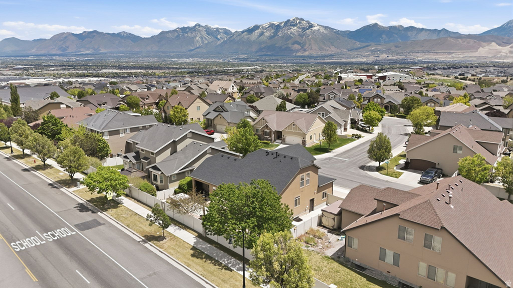 Residential neighborhood with a variety of housing styles, mature trees, and paved roads