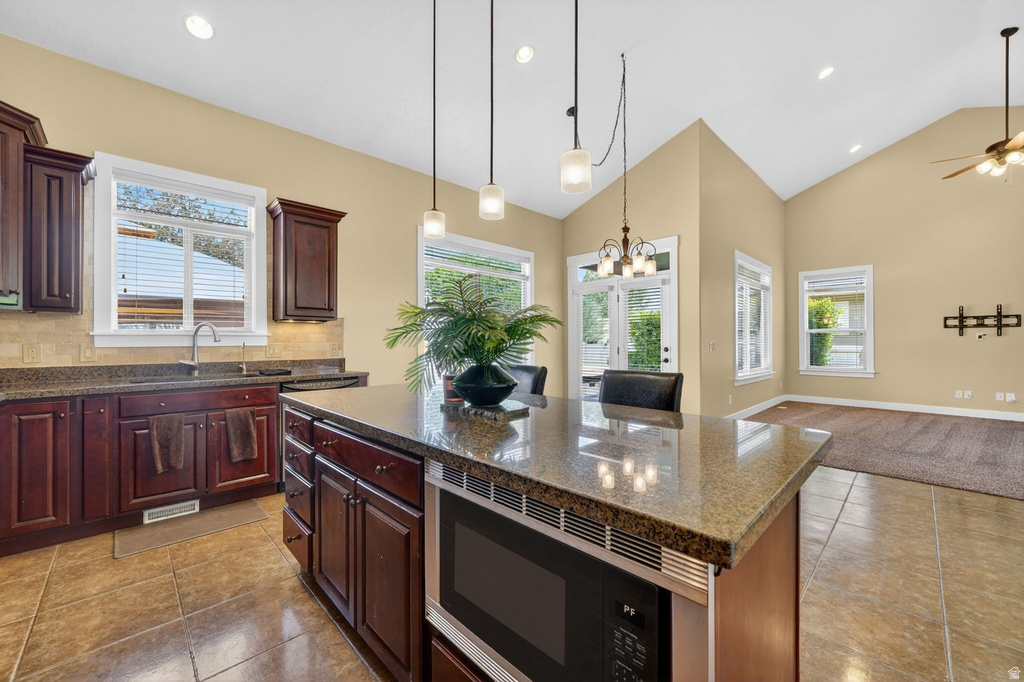 Kitchen island with stone-finish countertop and built-in microwave