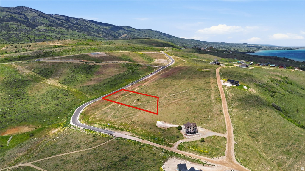 Clear building envelope surrounded by natural landscaping and mountain terrain