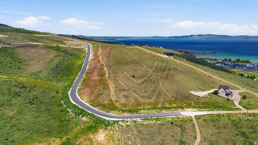 Paved road through lush green hillsides at Lakeview
