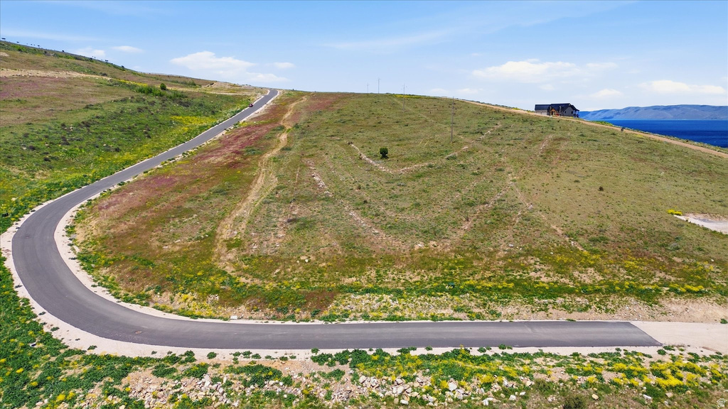 Hillside lot with autumn vegetation and distant lake scenery