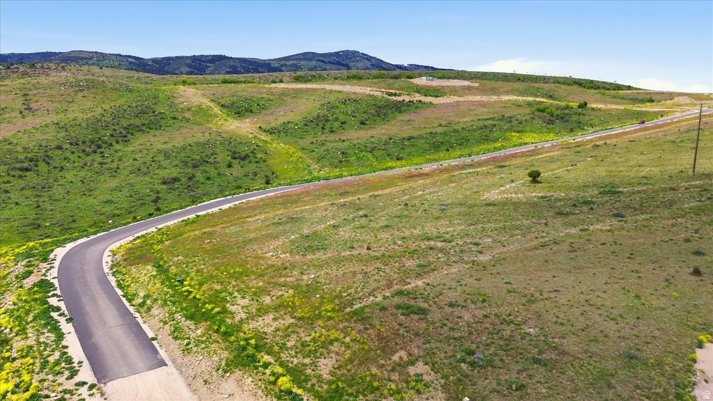 Curved paved road through expansive green hillsides