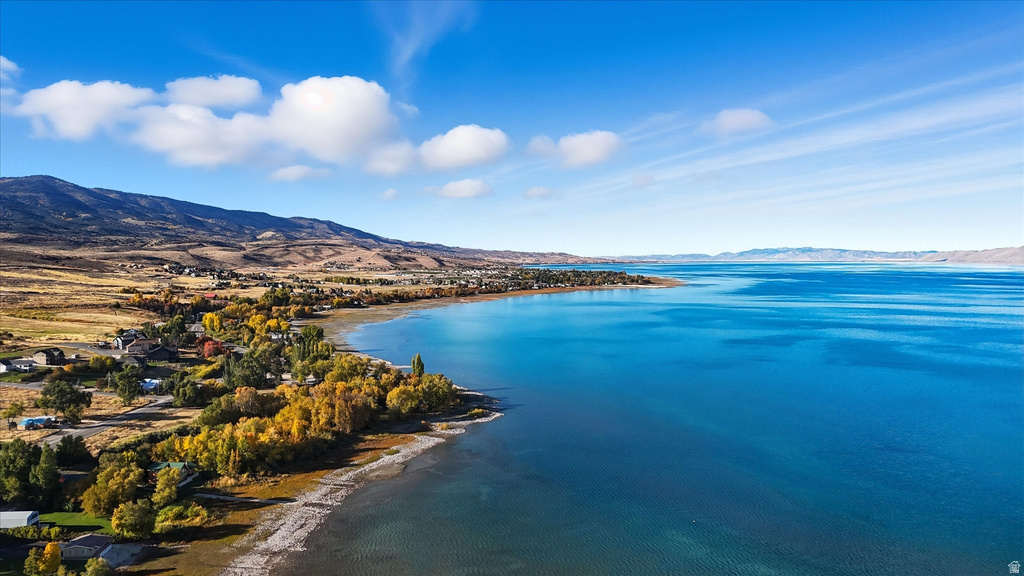 Bear Lake waterfront with autumn treeline and distant mountains