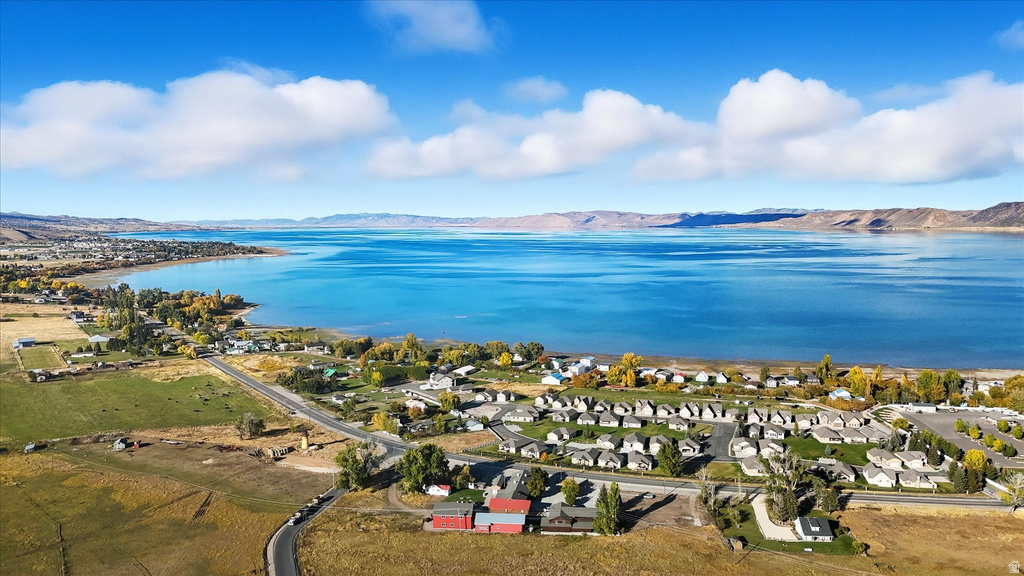 Expansive waterfront setting featuring a large body of water, coastal land, and mountainous terrain