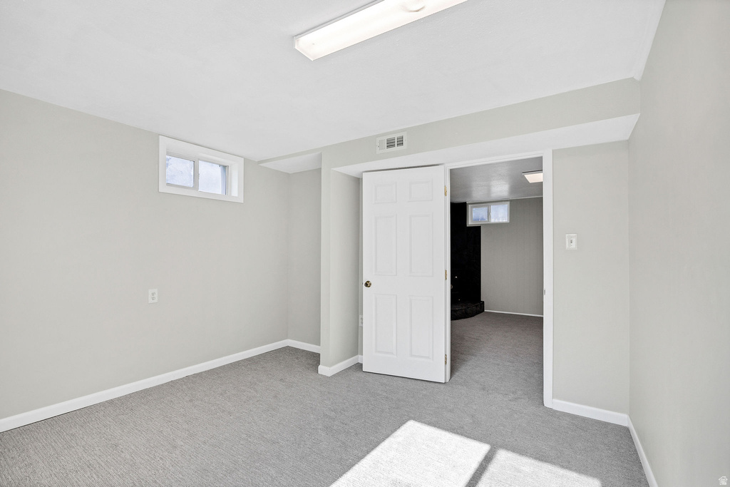 Carpeted room with light grey walls and white trim