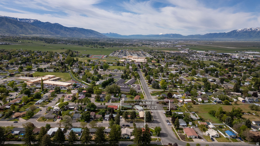 Aerial perspective of a residential area featuring a distinct neighborhood layout with multiple structures and paved roads