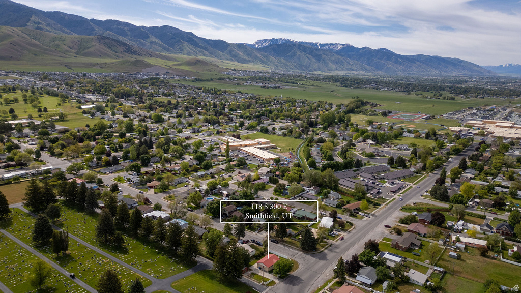 Aerial perspective showcasing a residential neighborhood with mountain backdrops