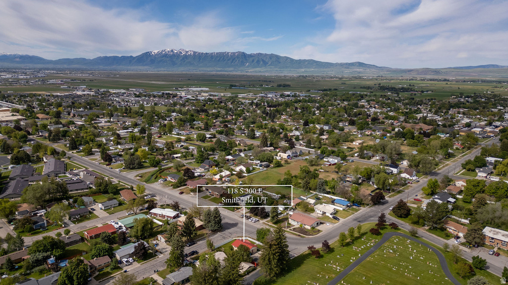 Aerial perspective of a residential neighborhood with a distant mountain backdrop