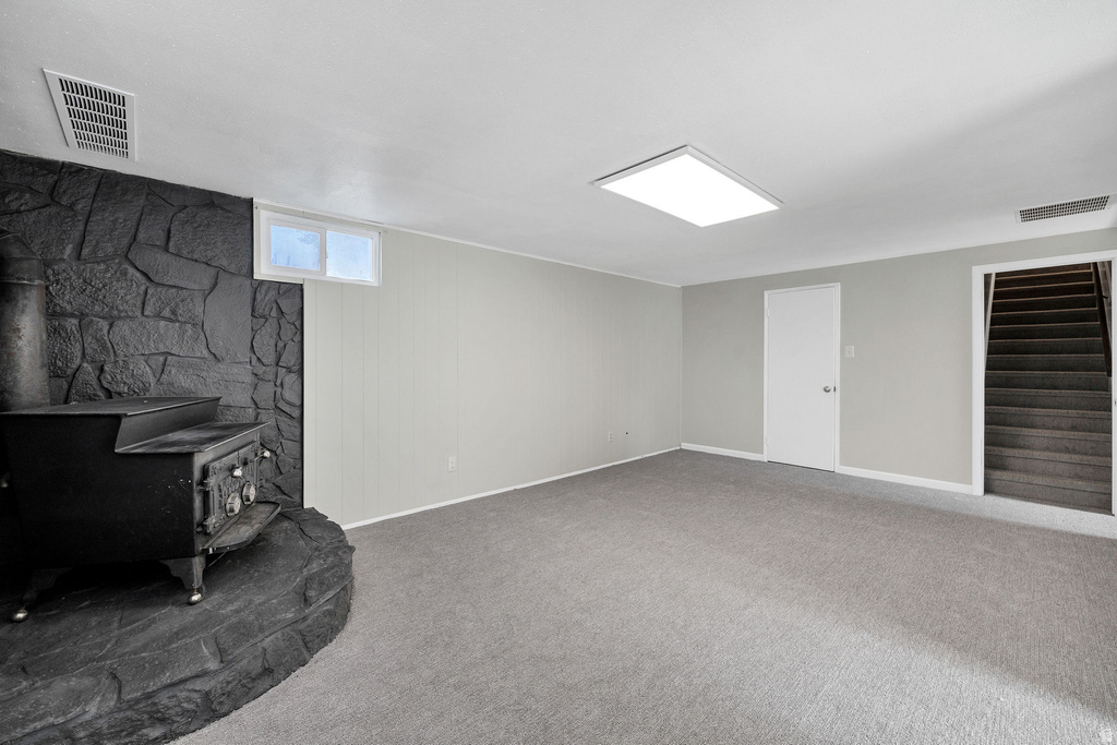 Spacious room with plush gray carpeting and light gray walls
