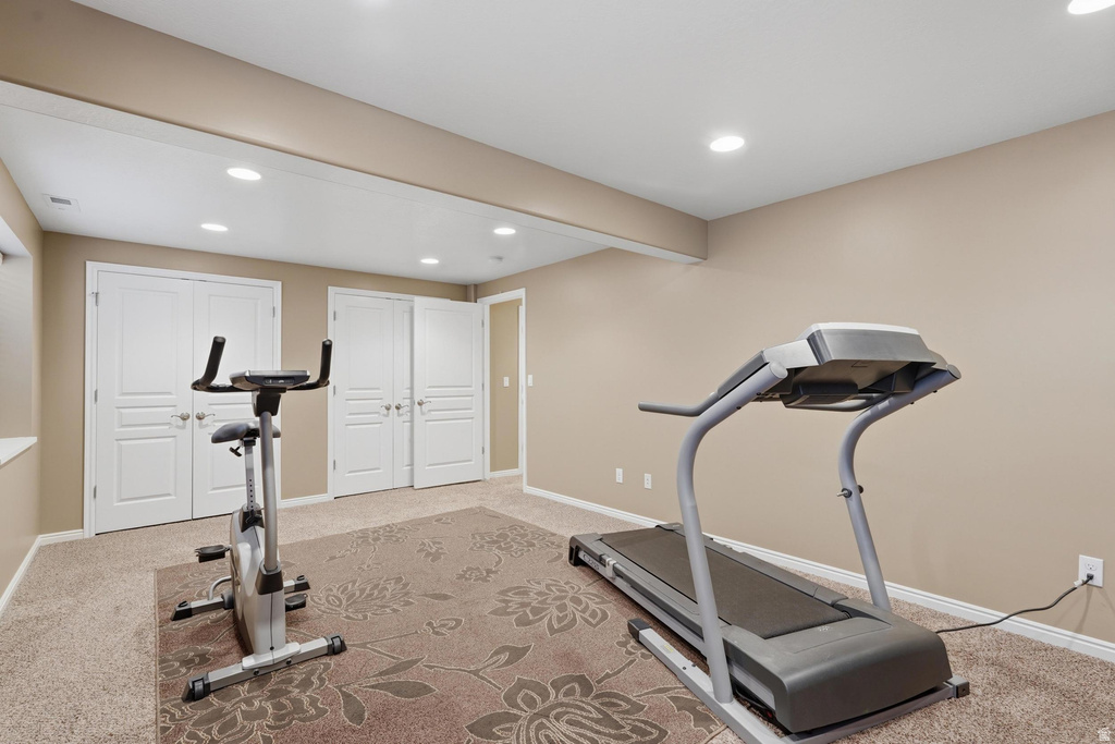 Carpeted room with recessed lighting, neutral wall paint, and white trim