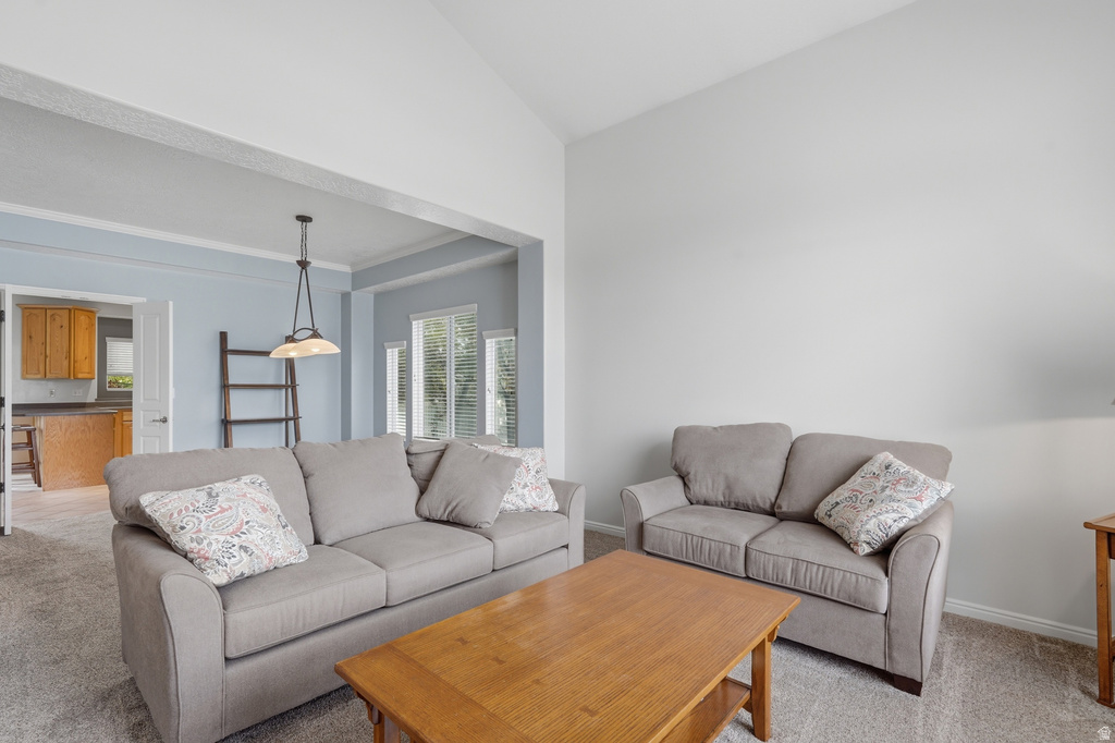 Vaulted ceilings with a neutral color palette, featuring a recessed opening with architectural trim leading to an adjacent room
