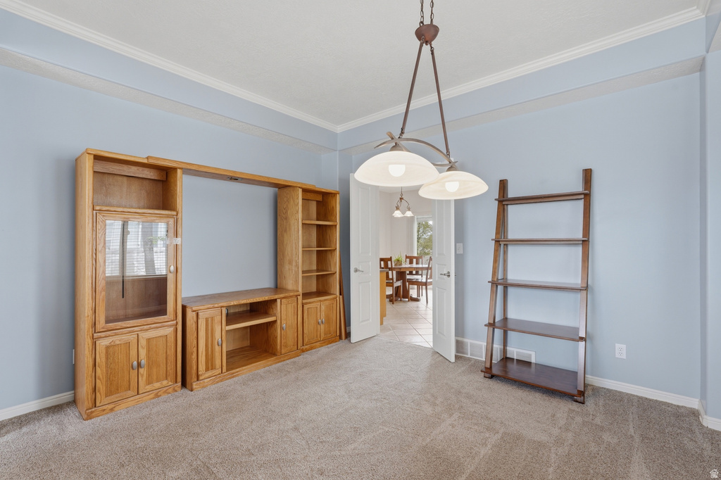 Built-in wood entertainment center with storage and shelving, complemented by a contemporary hanging light fixture