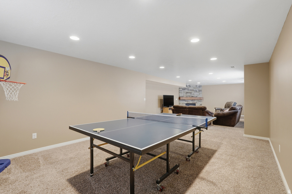 Spacious recreational room with recessed lighting and neutral-toned walls