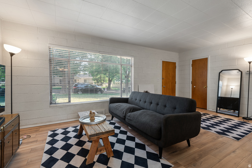 Light wood-finish flooring complements the white painted block walls