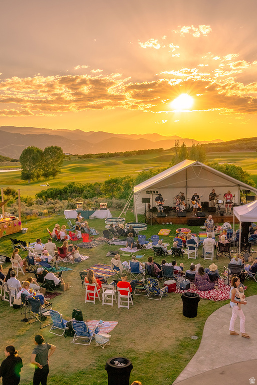 Expansive green lawn with a white event tent and stage