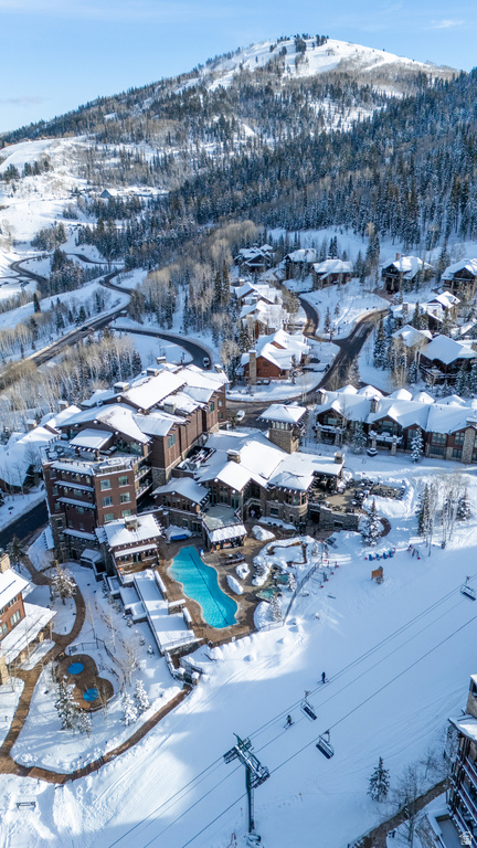 Expansive resort-style property with multiple buildings featuring a large outdoor pool and several outdoor spas