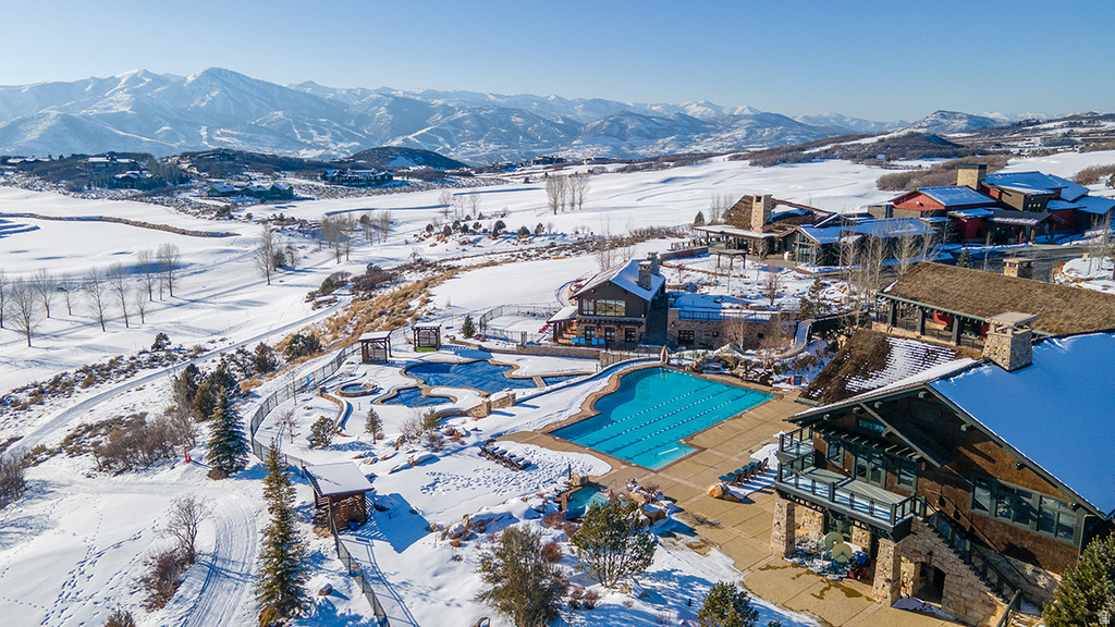 Expansive outdoor aquatic area featuring a multi-lane lap pool, multiple sculpted pools, and hot tubs