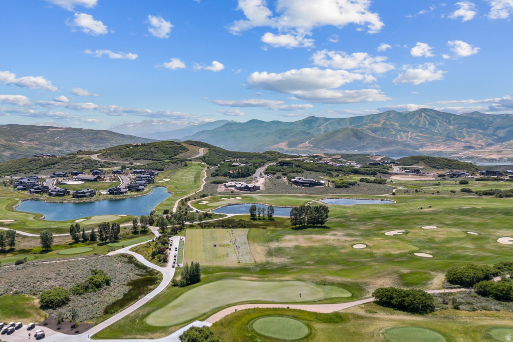 Expansive golf course setting featuring multiple greens, sand traps, and water features