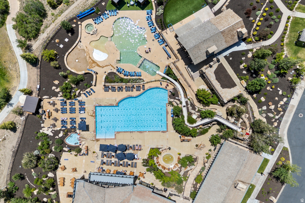 Expansive aquatic recreation area featuring a lap pool, a freeform leisure pool with a tanning ledge, a children\\\\\\\\\\\\\\\'s pool, and multiple water slides