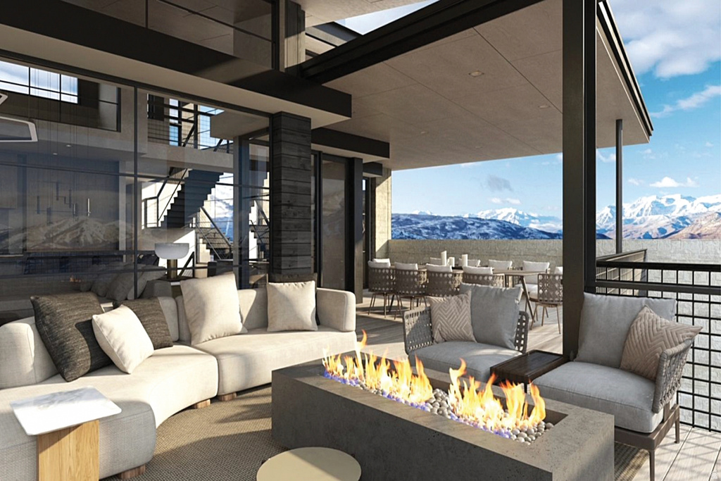 Expansive covered outdoor living area featuring a built-in fire pit with fire glass