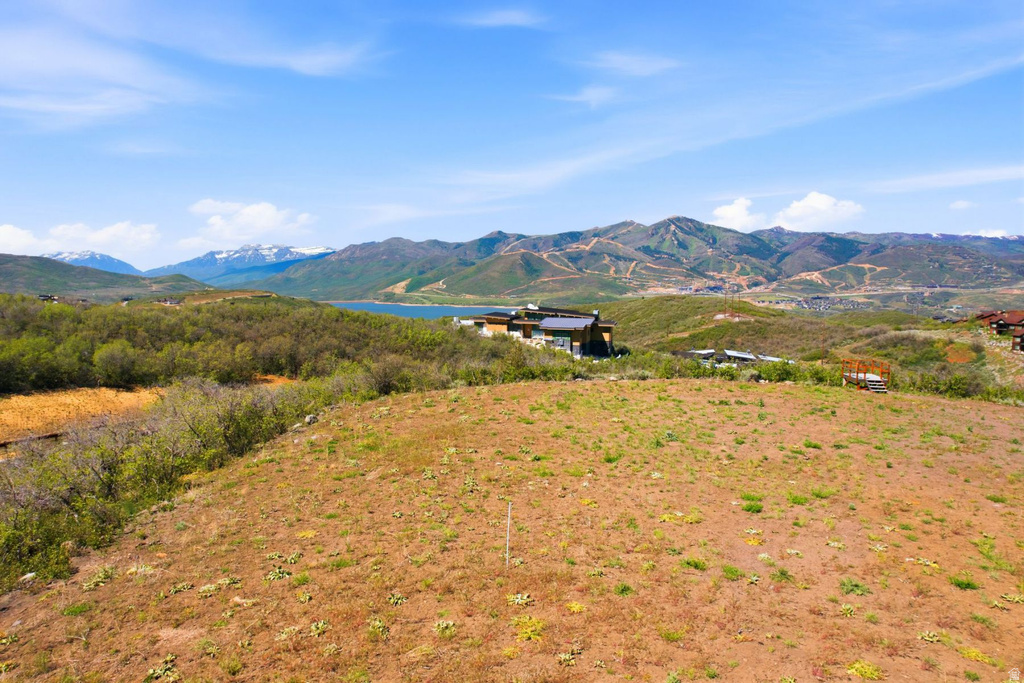 Expansive undeveloped lot with varying terrain, surrounded by natural vegetation