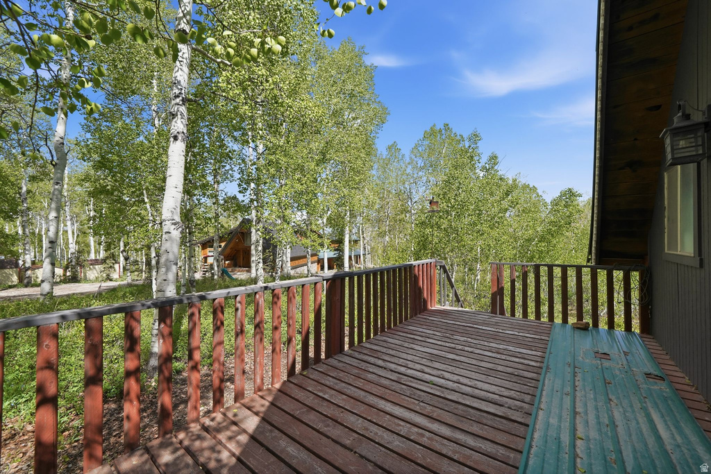 Expansive wood deck with wood plank flooring and a wood railing system