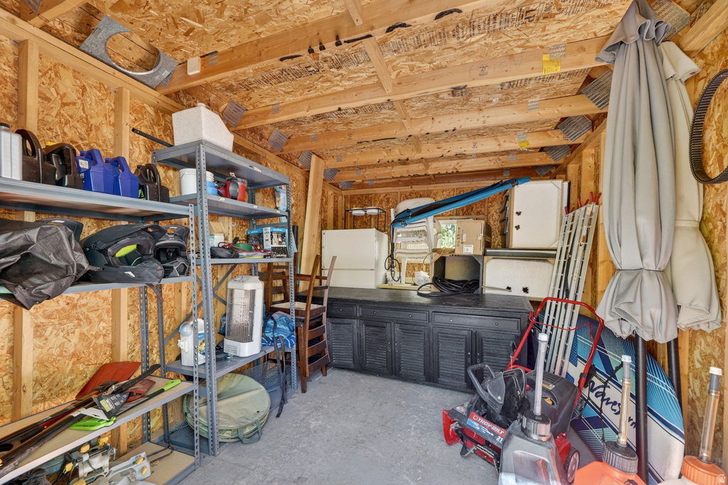 Interior storage structure featuring exposed wood framing and OSB wall and ceiling panels
