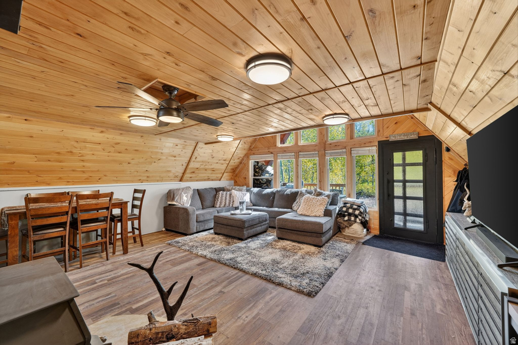 Vaulted ceiling with wood paneling and exposed beams