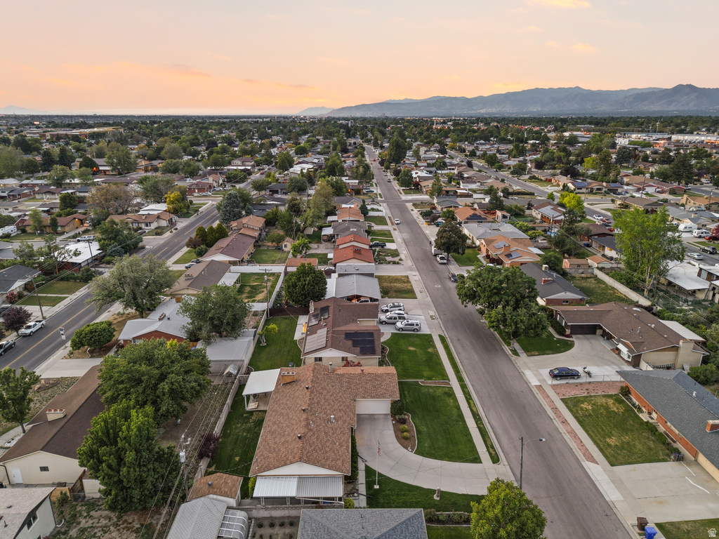 Residential neighborhood featuring established homes with diverse architectural styles, mature landscaping, and paved streets