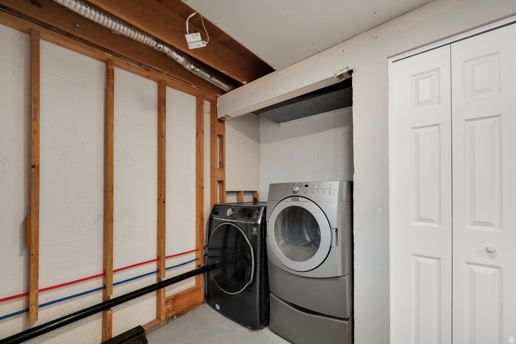 Laundry area with utility hookups and white bi-fold closet doors