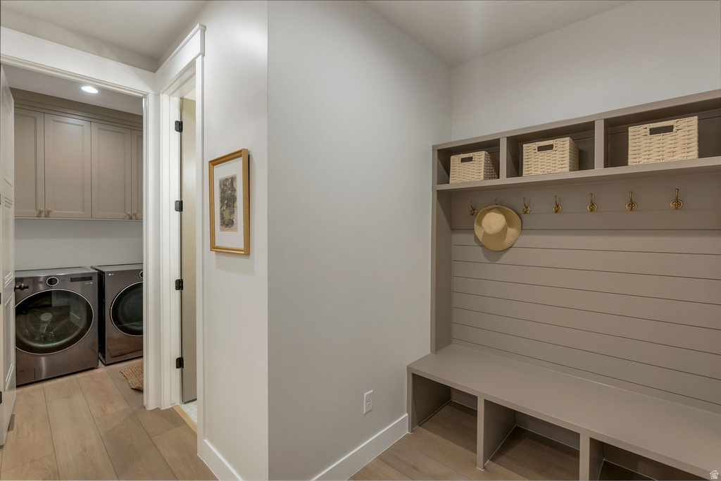 Mudroom with integrated bench seating, cubby storage, and wall hooks