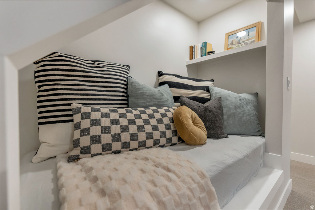 Built-in alcove seating with a cushioned base and integrated shelving
